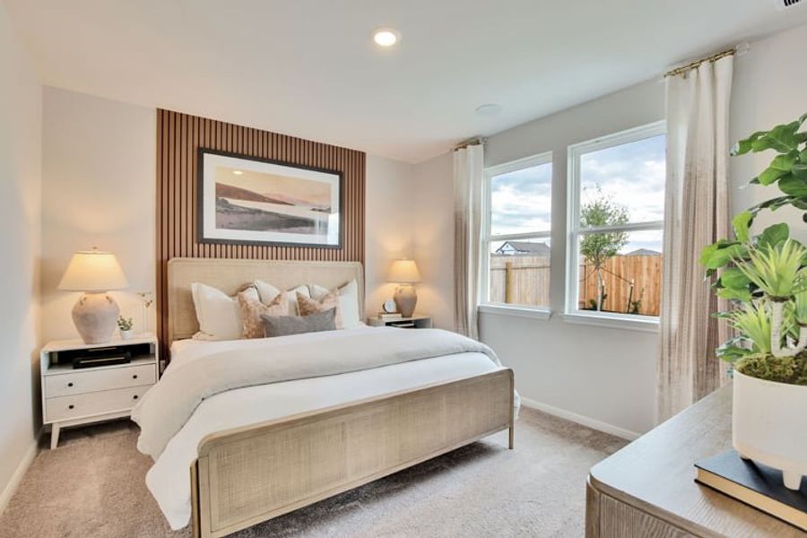 A bedroom with a large window. A bedroom with a large window.