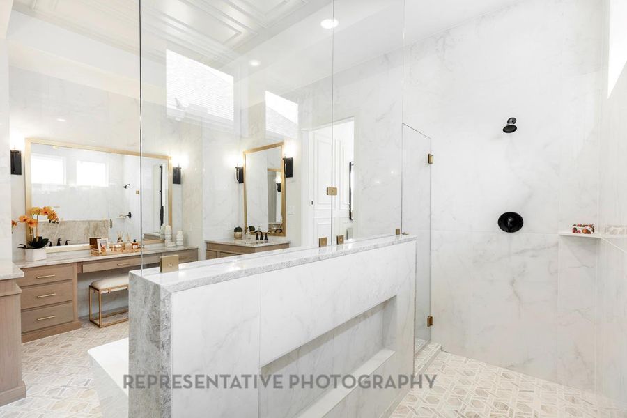 Full bath featuring a marble finish shower and vanity Full bath featuring a marble finish shower and vanity