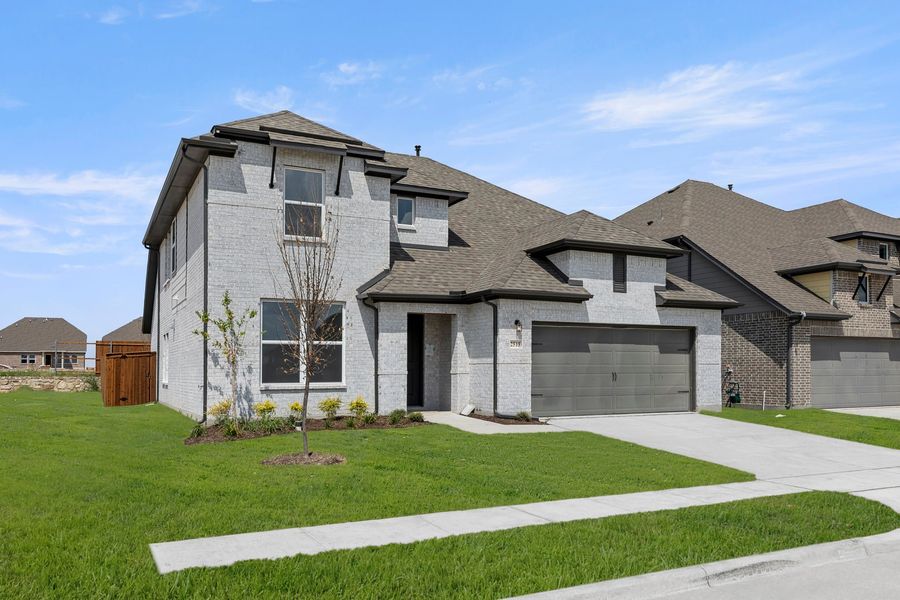 Front exterior of a new home in Walden Pond, Forney, TX, highlighting curb appeal (Image 2). Front exterior of a new home in Walden Pond, Forney, TX, highlighting curb appeal (Image 2).