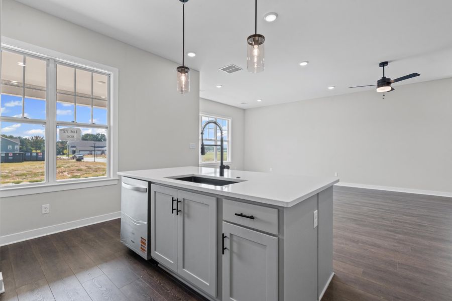Kitchen featuring pendant lighting, an island with sink, open floor plan, dark wood-style flooring, and recessed lighting Kitchen featuring pendant lighting, an island with sink, open floor plan, dark wood-style flooring, and recessed lighting