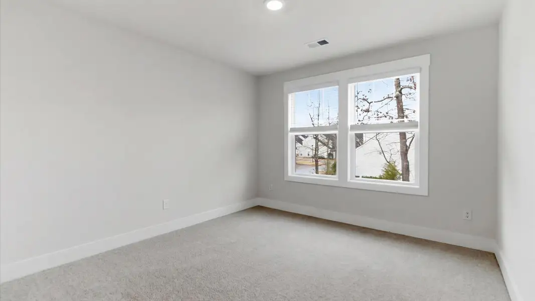Memorable bedroom with generous proportions, a walk-in closet, and beautiful natural light through large windows in SC