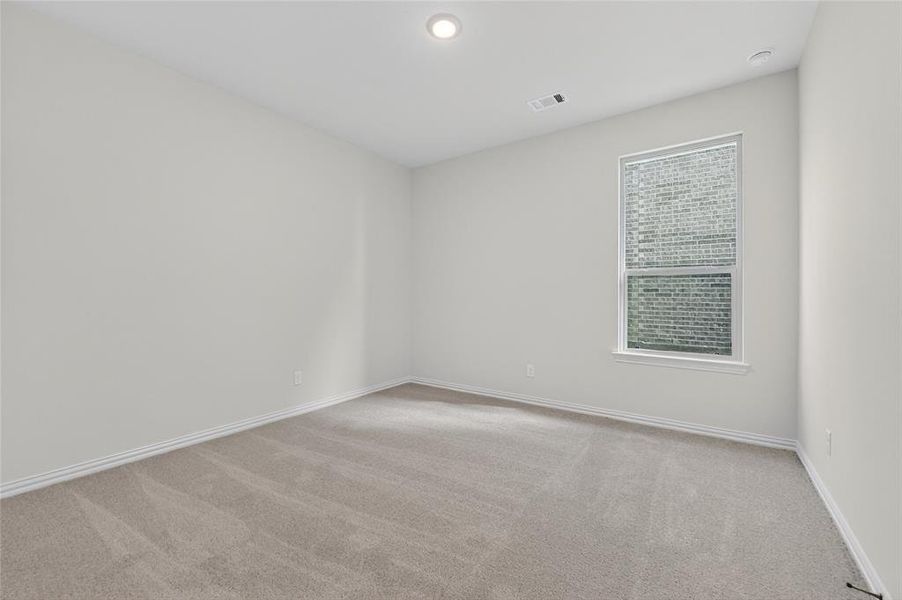Spare room featuring light colored carpet and baseboards