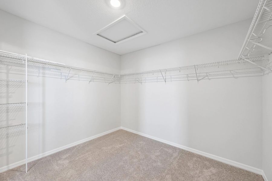 A very large walk-in closet is located off the primary bathroom