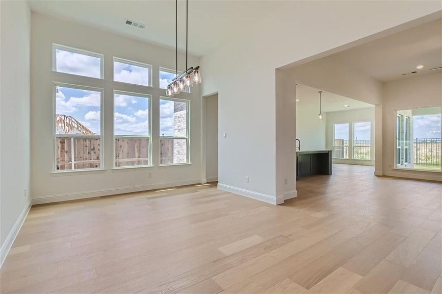 Unfurnished dining area with light hardwood / wood-style flooring and a chandelier