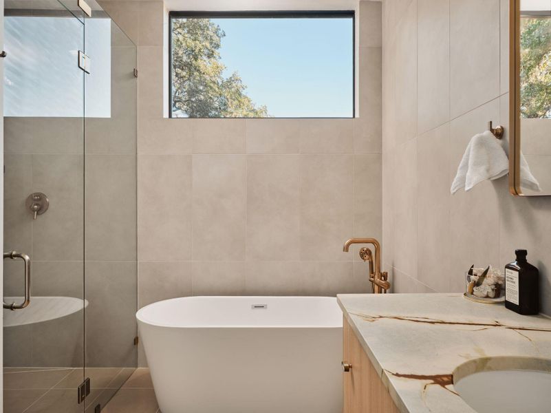 Bathroom featuring vanity, a stall shower, tile walls, and a freestanding bath