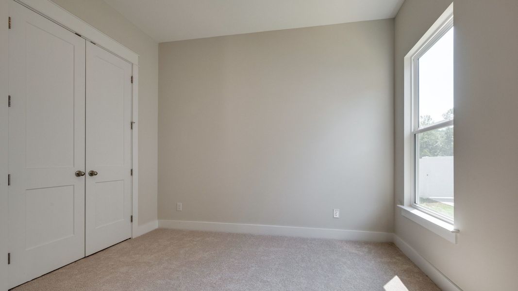 Secondary bedroom with double door closet next to front door