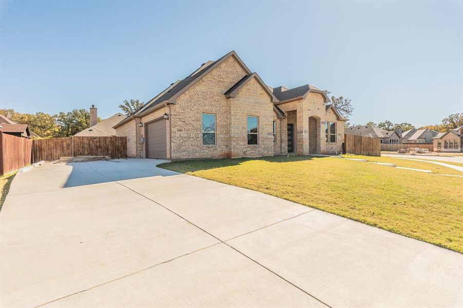 View of front of home featuring a front yard and a garage