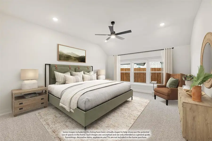 Bedroom with vaulted ceiling, ceiling fan, green upholstered bed, and large windows with natural light