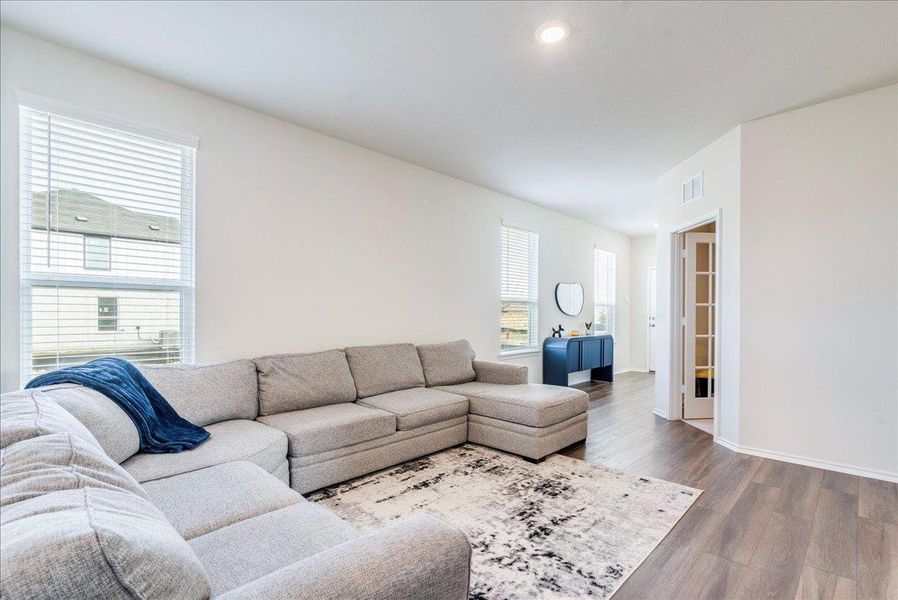 Living room features recessed lighting and LVP flooring Living room features recessed lighting and LVP flooring