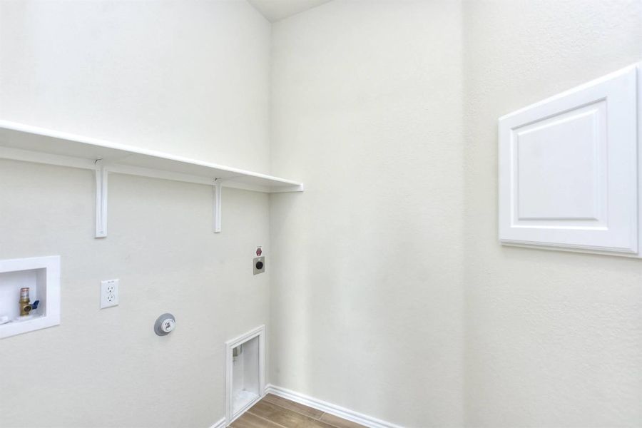 Laundry room featuring hookup for a washing machine, wood finished floors, baseboards, laundry area, and electric dryer hookup