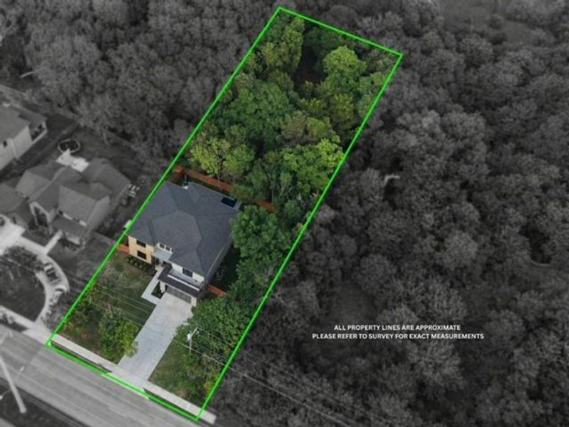 Property featuring a multi-level roofline, a concrete driveway, and a wooden privacy fence