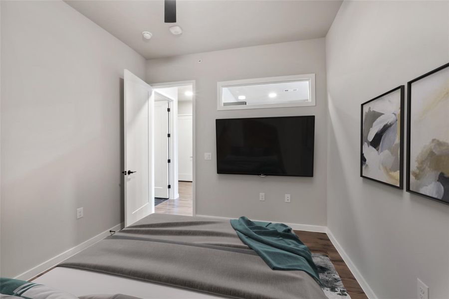 Bedroom featuring wood finished floors and baseboards