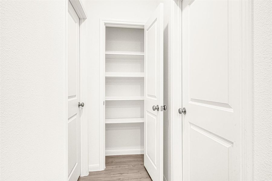 Clean hallway view showcasing the home's updated interior doors and neutral paint tone.