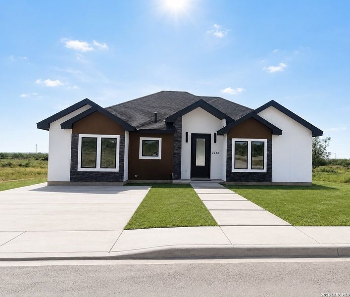 Front exterior of a new home in , Eagle Pass, TX, highlighting curb appeal (Image 24).