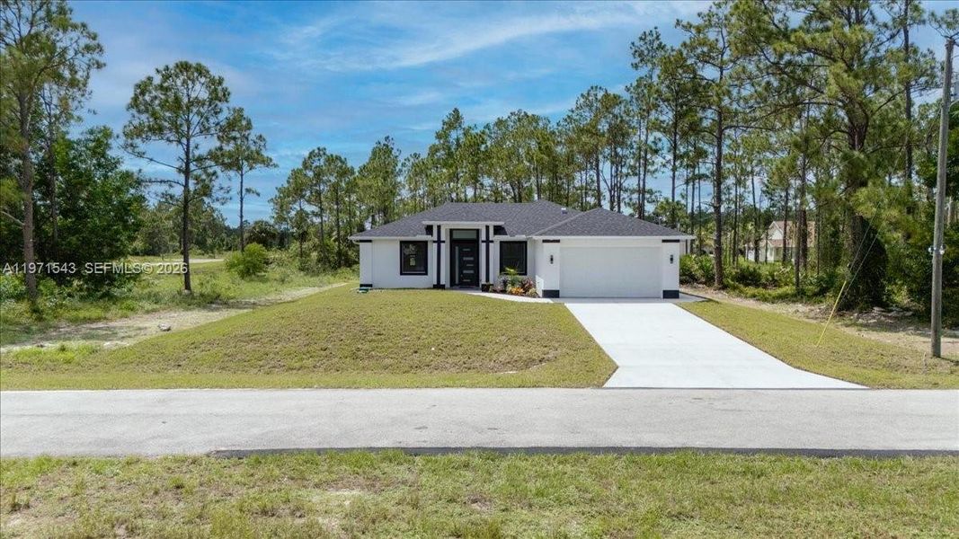 Front exterior of a new home in , Lehigh Acres, FL, highlighting curb appeal (Image 28).