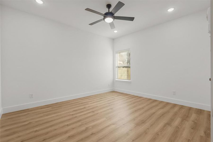 Empty room featuring ceiling fan and light hardwood / wood-style floors