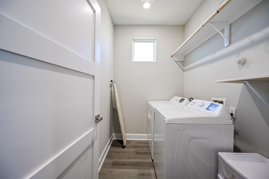 Spacious laundry room to accommodate full washer/dryer and storage shelving.