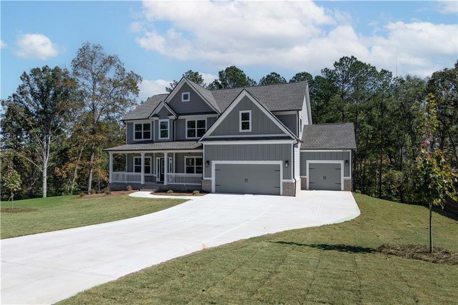 Front exterior of a new home in Woodland Hills, Loganville, GA, highlighting curb appeal (Image 1). Front exterior of a new home in Woodland Hills, Loganville, GA, highlighting curb appeal (Image 1).