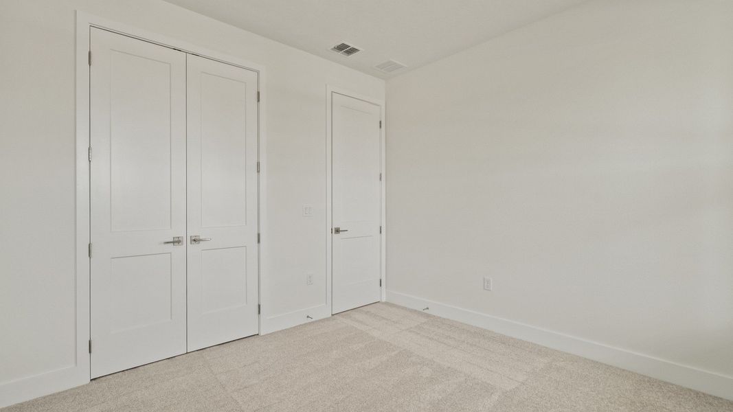 Spacious Bedroom with large closet in the Buttonwood floorplan by DRB Homes at Lakeside at Satilla in Saint Cloud, FL