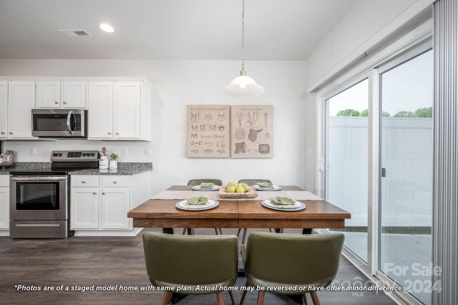 Dining area & kitchen with access to patio