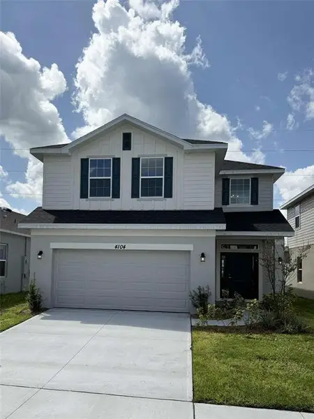 Front exterior of a new home in Harmony Central, St. Cloud, FL, highlighting curb appeal (Image 2). Front exterior of a new home in Harmony Central, St. Cloud, FL, highlighting curb appeal (Image 2).