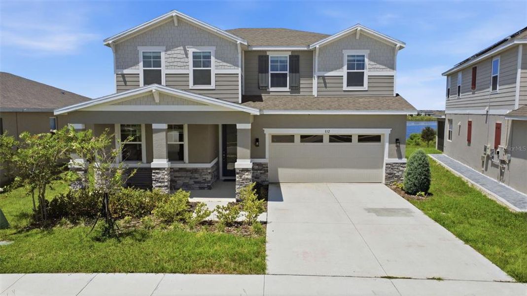 Front exterior of a new home in Seasons at Eden Hills, Lake Alfred, FL, highlighting curb appeal (Image 2). Front exterior of a new home in Seasons at Eden Hills, Lake Alfred, FL, highlighting curb appeal (Image 2).