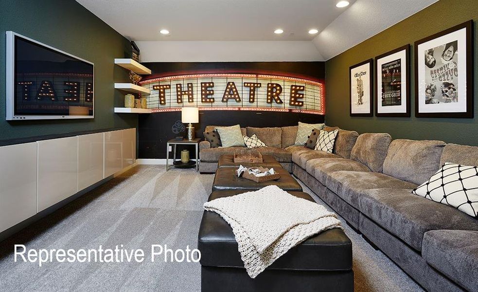 Carpeted living room with lofted ceiling