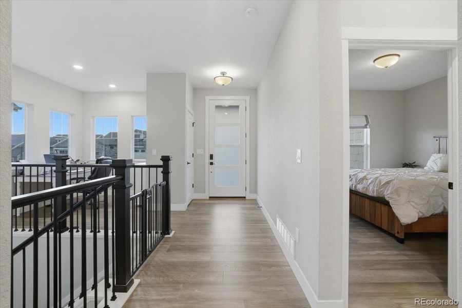 Welcome home! The entry of the home is well lit thanks to the glass inserts in the front door and the front windows in the office nook at the front of the home.