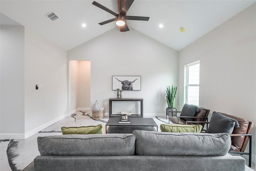 Living room with high vaulted ceiling and ceiling fan