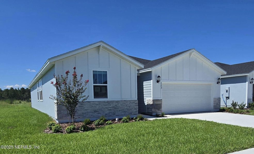 Front exterior of a new home in Lakes at Bella Lago - Signature Series, Green Cove Springs, FL, highlighting curb appeal (Image 20).