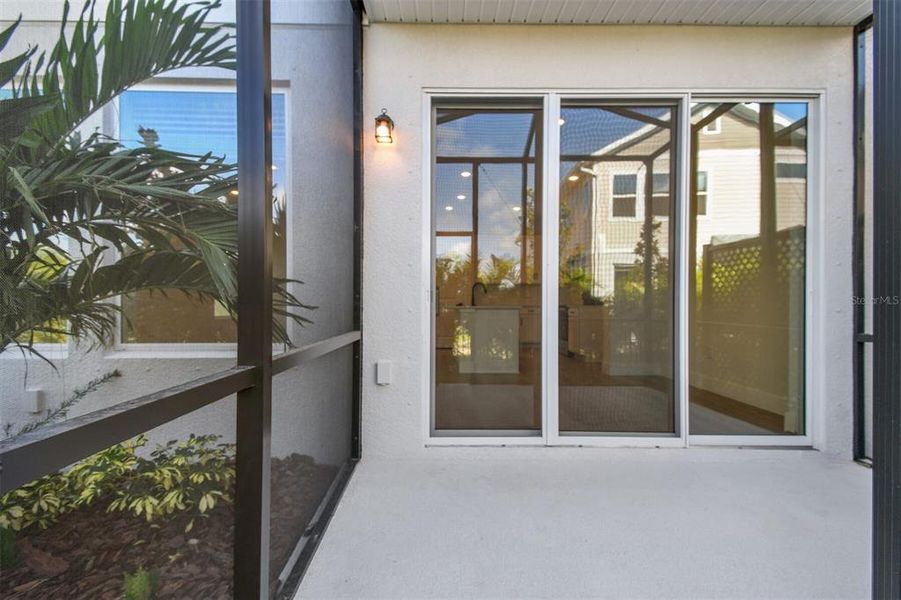 Exterior details and patio area of a home in North River Ranch – Townhomes, Parrish (Image 3).