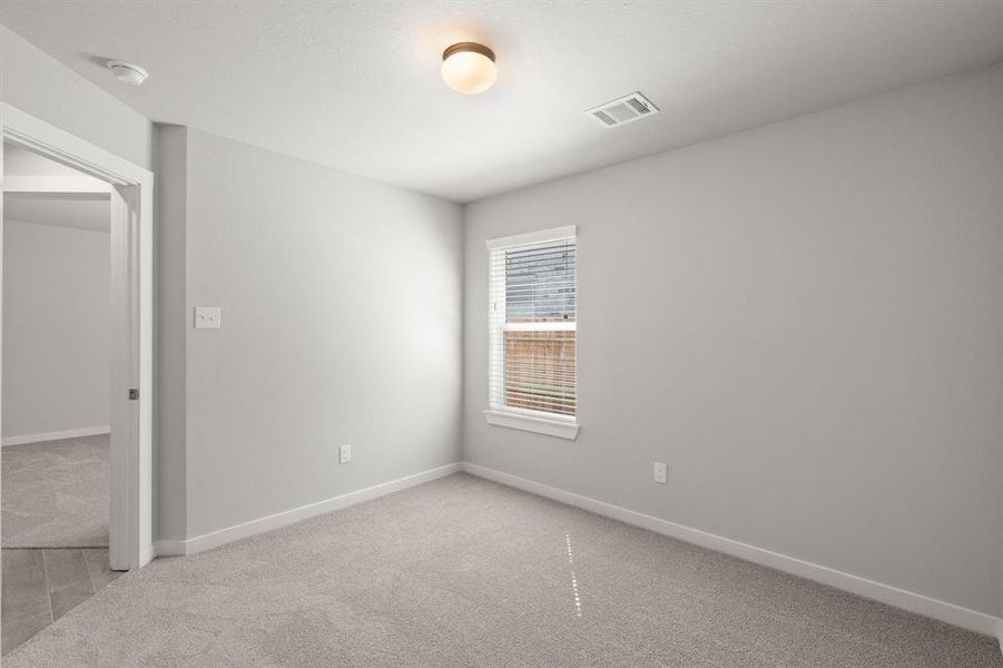 Generously sized secondary bedrooms featuring spacious closets, soft and inviting carpeting underfoot, large windows allowing plenty of natural light, and the added touch of privacy blinds for your personal retreat. Sample photo of completed home with similar floor plan. As-built interior colors and selections may vary.