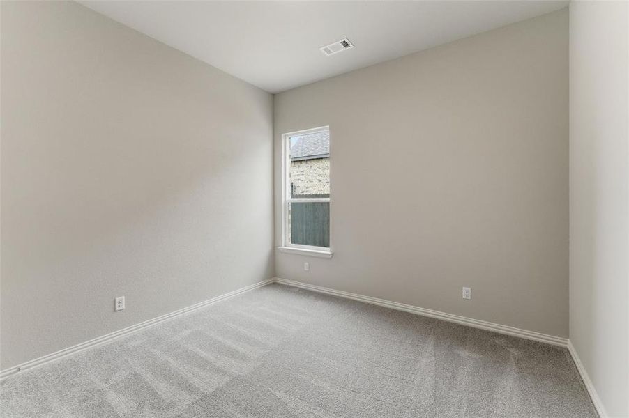 Unfurnished room with light colored carpet and baseboards