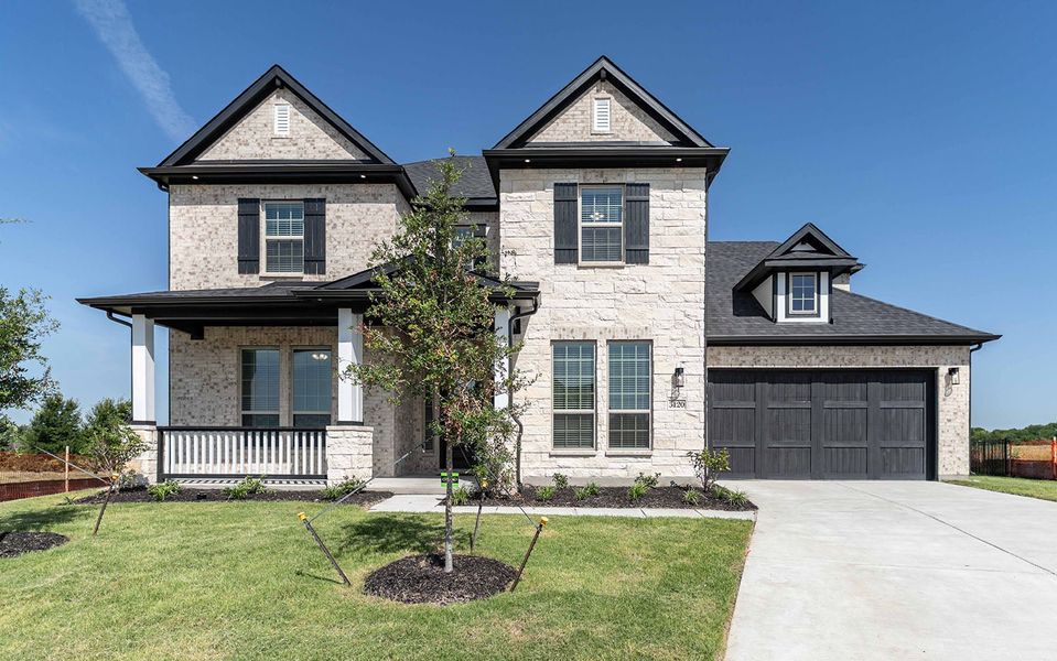 Front exterior of a new home in Heath Golf & Yacht Club, Heath, TX, highlighting curb appeal (Image 1). Front exterior of a new home in Heath Golf & Yacht Club, Heath, TX, highlighting curb appeal (Image 1).