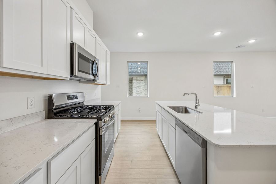 Kitchen in the Magnolia home plan by Trophy Signature Homes – REPRESENTATIVE PHOTO