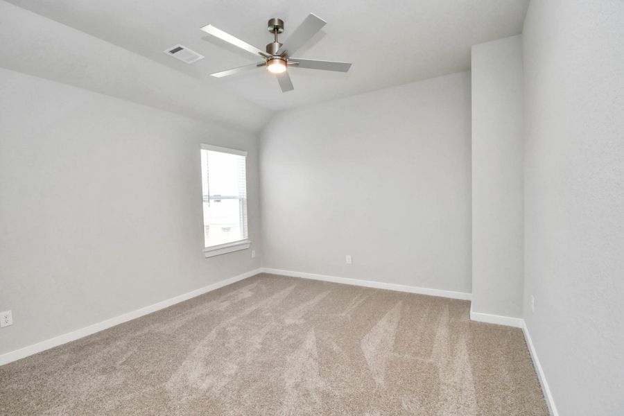 Secondary bedroom features plush carpeting, large windows that let in plenty of natural light, bright paint, and spacious closets. Sample photo of completed home with similar floor plan. Actual colors and selections may vary. Secondary bedroom features plush carpeting, large windows that let in plenty of natural light, bright paint, and spacious closets. Sample photo of completed home with similar floor plan. Actual colors and selections may vary.