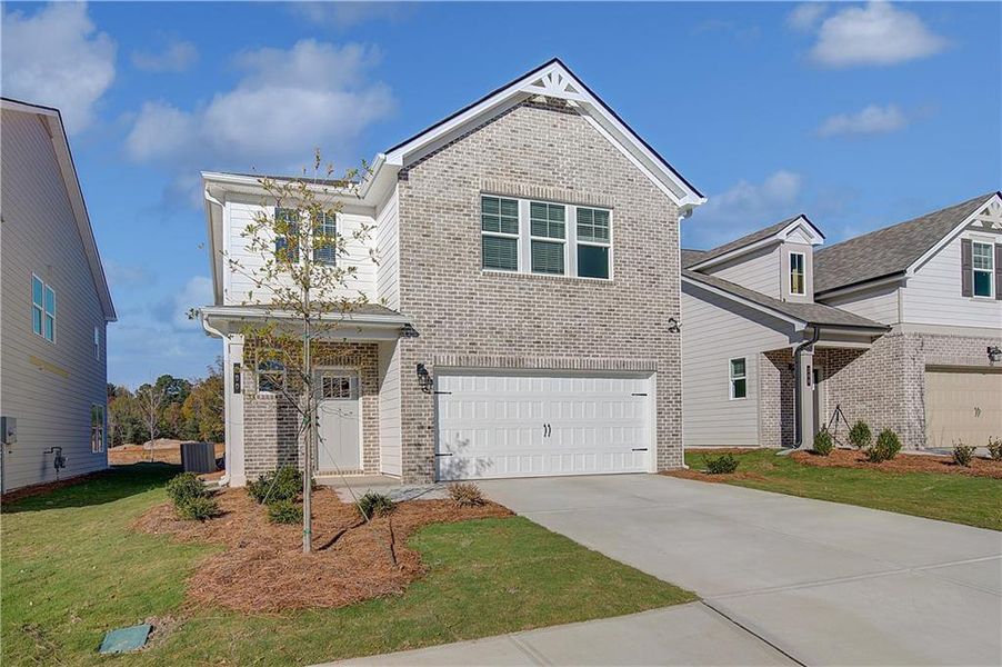 Front exterior of a new home in Abbotts Crossing, Conyers, GA, highlighting curb appeal (Image 14).
