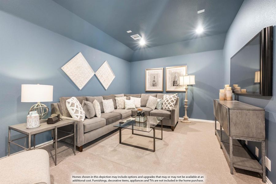 Living room with gray sectional sofa, glass coffee table, wall-mounted TV, and blue-gray walls with vaulted ceiling