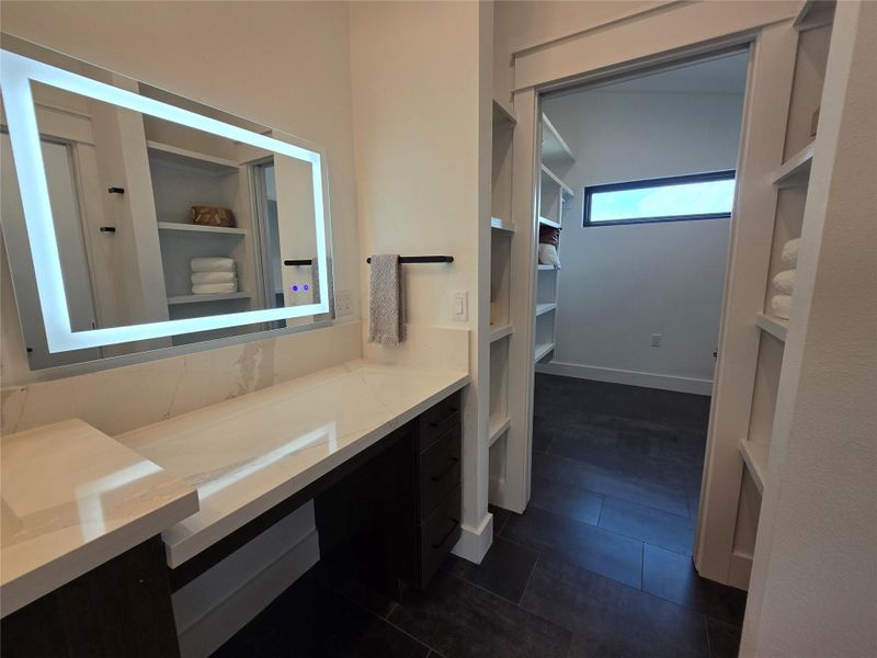 The LED backlit mirror in the makeup vanity area.