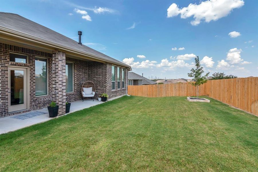 Fenced backyard with a patio