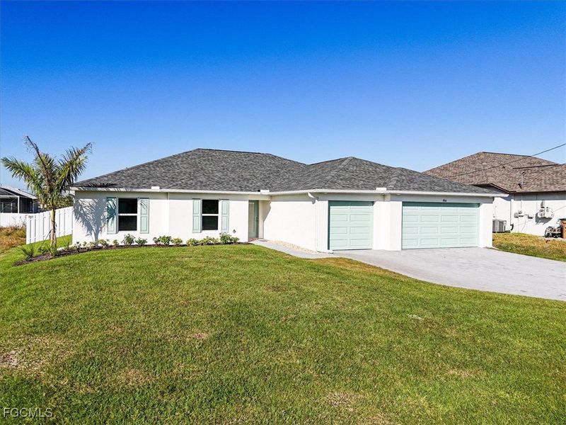 Front exterior of a new home in Cape Coral, Cape Coral, FL, highlighting curb appeal (Image 2). Front exterior of a new home in Cape Coral, Cape Coral, FL, highlighting curb appeal (Image 2).