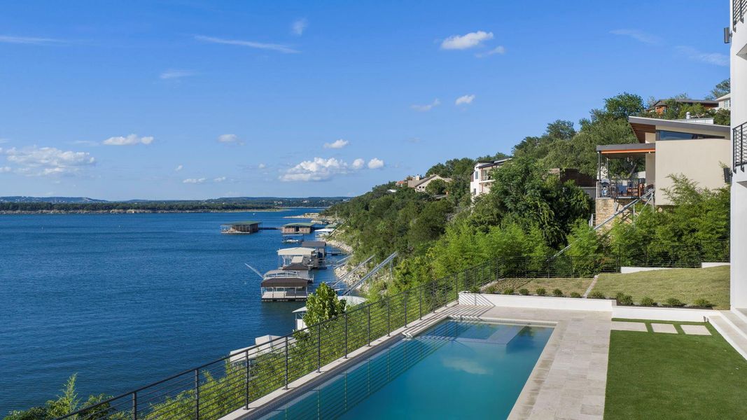 Experience lakeside living from this cliffside pool, overlooking expansive water views and private boat docks. Experience lakeside living from this cliffside pool, overlooking expansive water views and private boat docks.