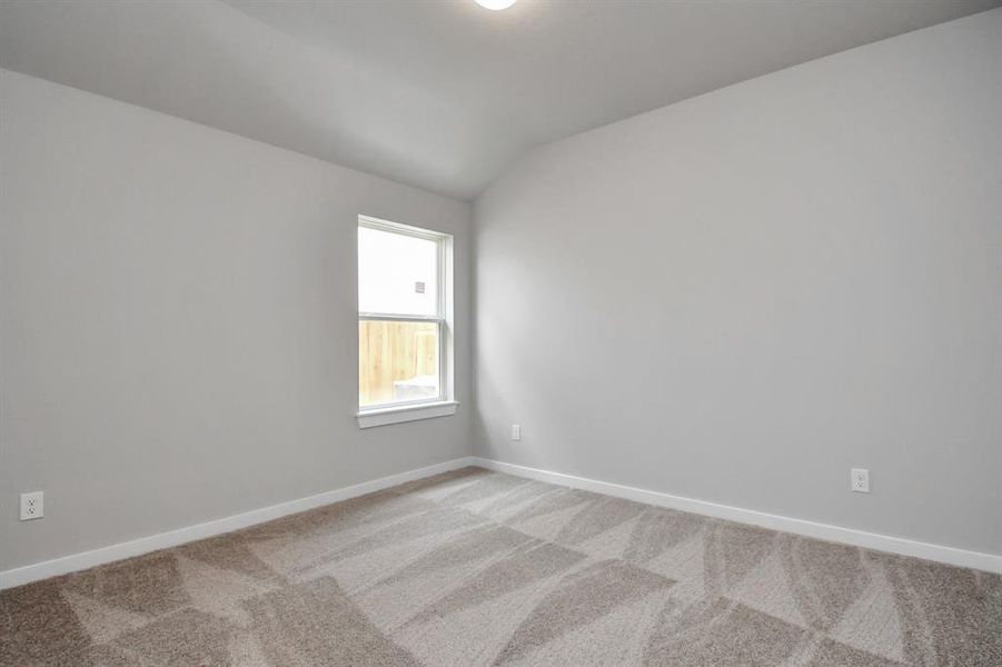 Secondary bedroom features plush carpeting, large windows that let in plenty of natural light, bright paint, and spacious closets.  Sample photo of completed home with similar floor plan. Actual colors and selections may vary.