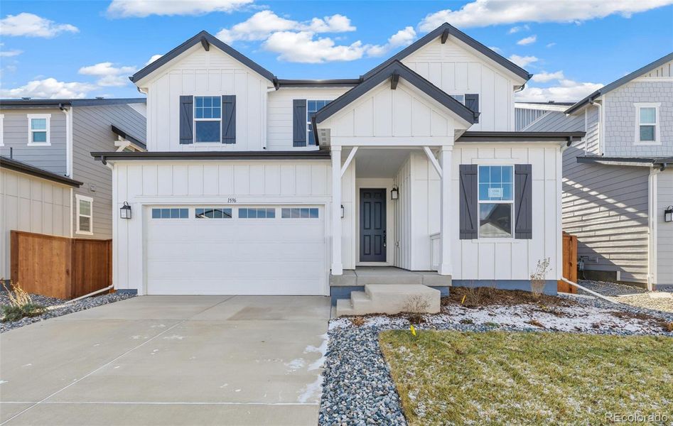 Front exterior of a new home in Farmlore, Brighton, CO, highlighting curb appeal (Image 21).