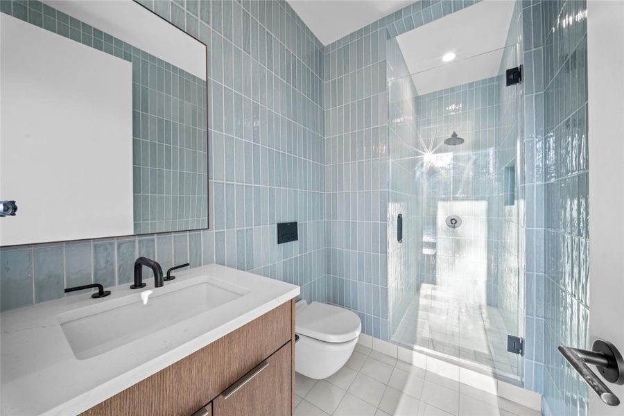 Lower level living room, bedroom 5 and full bath with direct access to the pool.