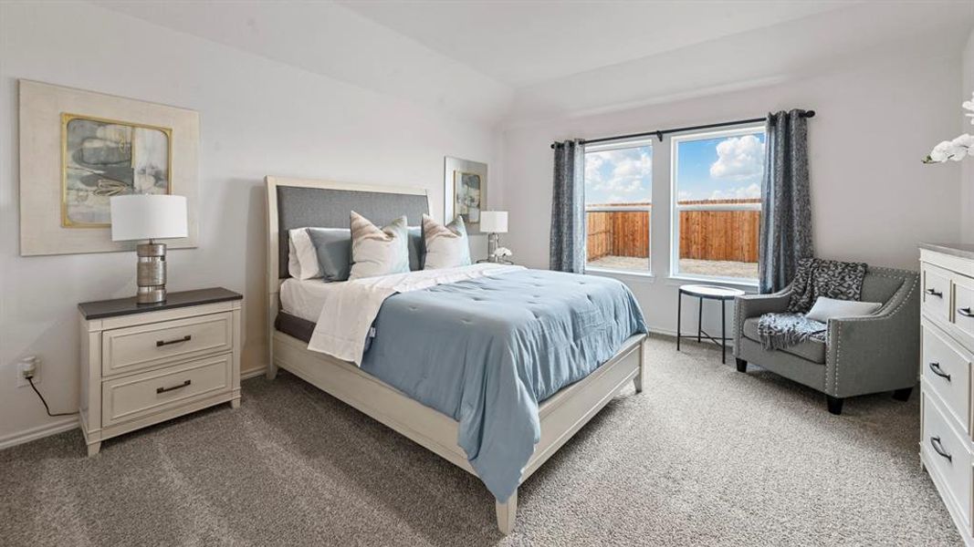 Bedroom featuring dark colored carpet and vaulted ceiling Bedroom featuring dark colored carpet and vaulted ceiling