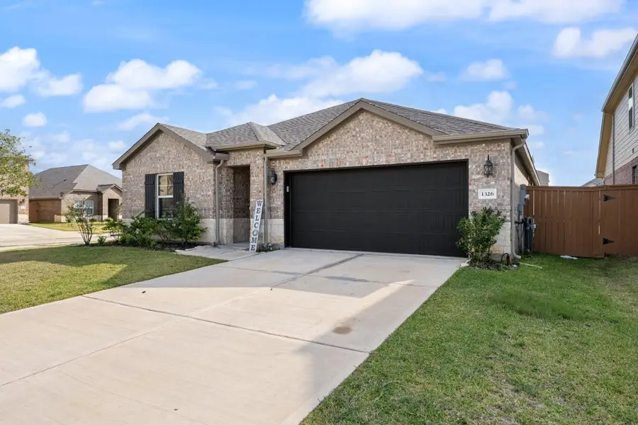Front exterior of a new home in Sierra Vista, Iowa Colony, TX, highlighting curb appeal (Image 2).