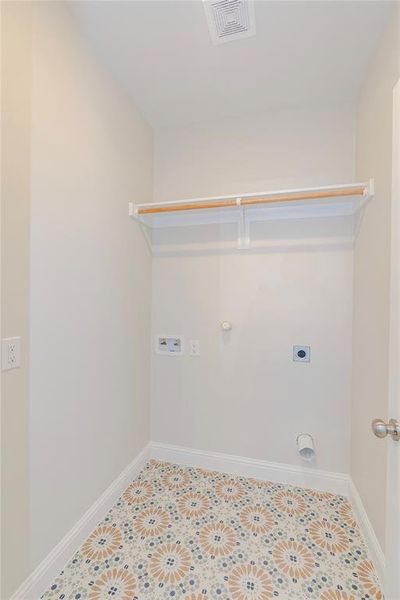 Washroom with washer hookup, electric dryer hookup, light tile patterned flooring, and hookup for a gas dryer