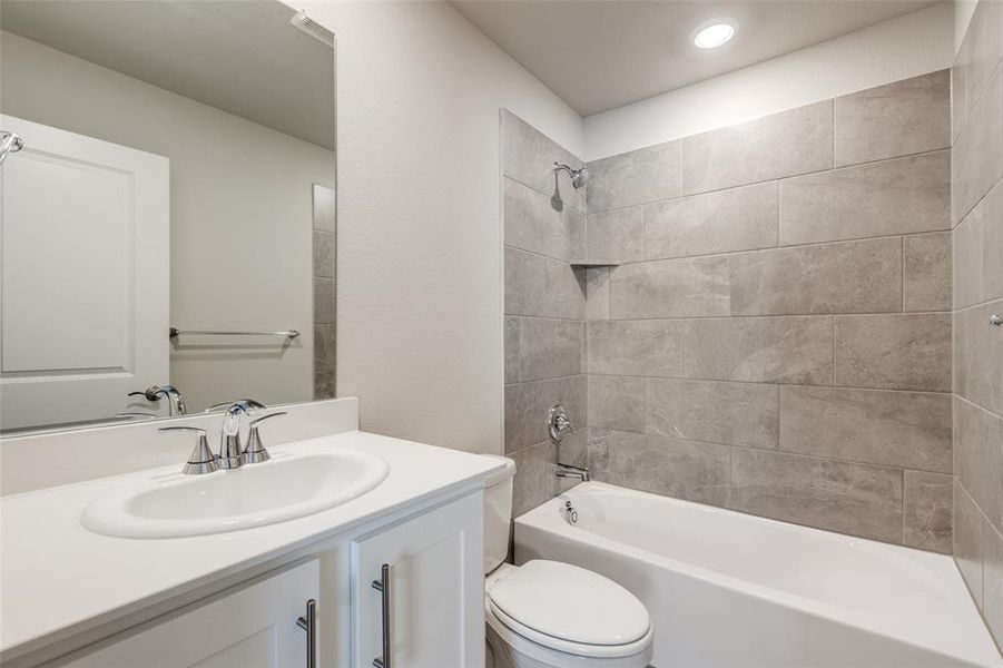 Bathroom featuring  shower combination and vanity