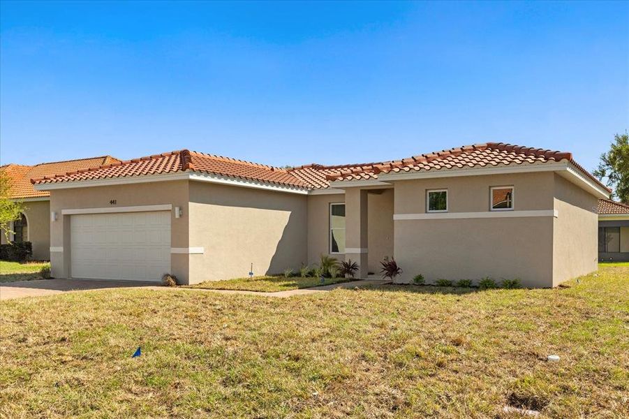 Front exterior of a new home in , Kissimmee, FL, highlighting curb appeal (Image 12).